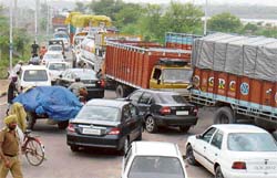 Chaos rules on the road in Sector 26 in Panchkula after trucks were held up following landslides in adjoining Himachal Pradesh