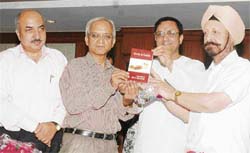Dr L.S. Chawla (right) releases a book “Herbs and Health”, a compilation of articles by R. Vatsyayan, in Ludhiana on Sunday.