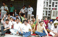 Joint Action Committee members stage a dharna on the Punjabi University campus in Patiala on Monday.