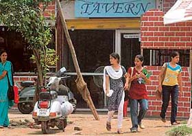 Students of Government College for Girls, Sector 42, stand in front of a tavern waiting for bus
