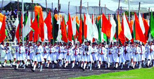 Schoolchildren march with tricolour flags to celebrate the 60th Independence Day at Chatrasal Stadium in the Capital on Wednesday.