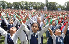 Kashmiri schoolchildren perform on the 60th anniversary of the Independence Day celebrations in Srinagar on Wednesday
