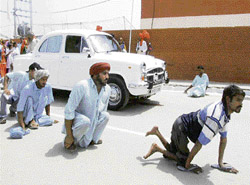 Physically challenged persons on way to receive tricycles at the Independence Day function in Bathinda on Wednesday.