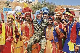 Indian UN peacekeeping soldiers, clad in traditional costumes, pose for a picture with a Spanish UN soldier (centre) during a ceremony to mark India's 60th anniversary as an independent nation, at their base in Ibl al-Saqi village in south Lebanon on Wednesday.
