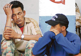 Grieving family members of cloudburst victims at a relief camp set up near the village on Thursday.
