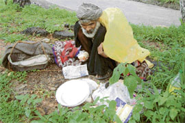 This old man was found satiating his hunger with food salvaged from a dustbin at Dharamsala. 