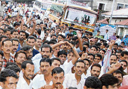 Taxi operators block traffic near the post office, Dharamsala, on Thursday in protest against the stipulation for installing meters in their vehicles.