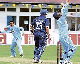 Piyush Chawla (left) celebrates the dismissal of Scotlands Neil McCallum during the ODI at Glasgow on Thursday.