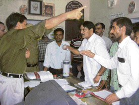 Pradesh Congress Committee member and former MLA Krishan Kumar Kaushal argues with the Bilaspur CDPO over the selection of anganwari workers on Friday. 