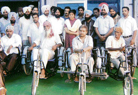 Alaknanda Dayal, deputy commissioner, Fatehgarh Sahib, distributes tri-cycles to physically challenged at Mandi Gobindgarh
