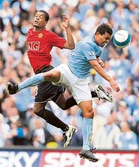 Manchester Citys Geovanni (right) fights for the ball with Manchester Uniteds Patrice Evra during the English Premier League football match