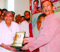 DPCC president Ram Babu Sharma honours Kavi Santosh Anand to mark the 63rd birth anniversary of Rajiv Gandhi in the Capital on Monday.