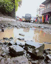 One of the main roads with deep potholes at Tutu in Shimla on Monday.