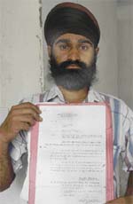 Kuldeep Singh shows the appointment letter issued to him in March 2005
