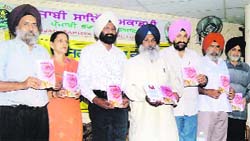 Darshan Shiwalik releases the book ‘Piyar De Rabab’ written by Surjit Singh Lambran (in white turban) in Ludhiana on Sunday.