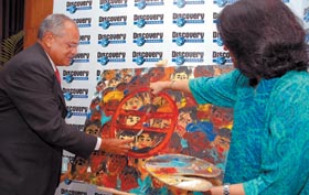 Deeeepak Shourie, EVP and MD, Discovery Network India, gives final touches to the Delhi Metro logo at a press conference in the Capital on Tuesday.