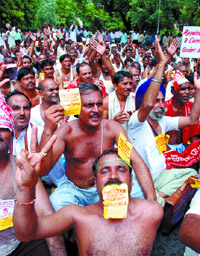Activists of the All India Postal Extra -departmental Employees Union stage a dharna at Sansad Marg in the Capital on Wednesday.