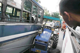 A collision between a tractor and a bus near Arla, 25 km from Dharamsala, on Wednesday led to the disruption of traffic on the Pathankot-Palampur road for two hours. Tribune photo