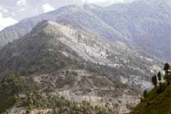 The hill clearly depicts the damage caused to green cover by a company executing a power project near Palampur