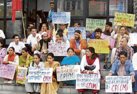 CPM workers stage a dharna in front of the municipal corporation office in protest against water shortage, in Shimla