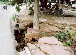 A scene of a road cave-in in Sector 22 following the recent heavy rains in Chandigarh.