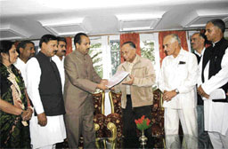 BJP leaders submit the report of the partys fact-finding committee, which inquired into former tourism minister G.S. Balis birthday party, to Governor V.S. Kokje at Raj Bhavan in Shimla on Sunday.