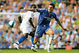 Chelseas Frank Lampard (right) gets past Portsmouths Sulley Muntari during their English Premier League soccer match at Stamford Bridge in London on Saturday. Chelsea won 1-0.