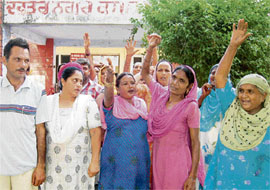 Banur MC employees protest in Banur on Monday. 