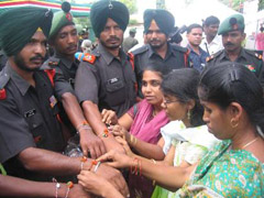 Visually impaired girls tie rakhis on the occasion of Raksha Bandhan to soldiers at Ranbirsinghpura in Jammu district