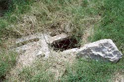 The drain has vanished and the place that housed it now serves as a dumping ground for broken pots