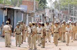 Police personnel patrol a street in Mauli Jagran after Dalit protesters resorted to stone-pelting in Chandigarh