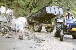 A damaged road under repairs in Dharamsala