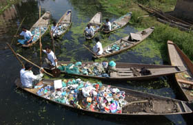 Volunteers from an NGO collect rubbish during a drive to clean up the Dal Lake in Srinagar