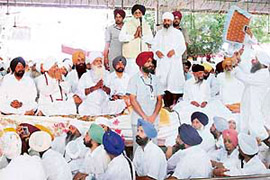 Chief Minister Parkash Singh Badal addresses a congregation at Nanksar Kaleran in Ludhiana district on Wednesday.