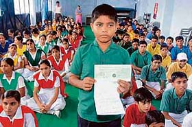 Shailendra, who recently cleared MCA examination at the age of 14, with the cheque for Rs 1.95 lakh, given to him by Maharashtra Congress MLA Kripa Shankar Singh for further studies, in Lucknow