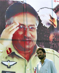 A man walks past a billboard showing Pakistan President Gen Pervez Musharraf near the Supreme Court in Islamabad on Wednesday.