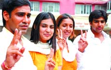 NSUI candidates for DUSU polls: Devraj Tehlan, Amrita, Khushboo Sharma and Manish Choudhary show the victory sign after a press conference in the Capital on Friday.