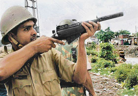 A policeman aims a shot to disperse protesters 