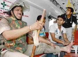 Paramedical staff administers first-aid to a policeman injured during a clash in Rajiv Colony, Panchkula