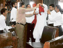 A security personnel overpowers one of the members of the Panthers Party protesting against the suspension of Harsh Dev Singh in Srinagar on Friday.
