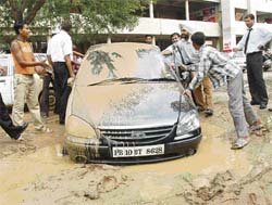 The parking lot at the Ludhiana District Courts complex is in a shambles and visitors have to wade through slush for want of metalled parking