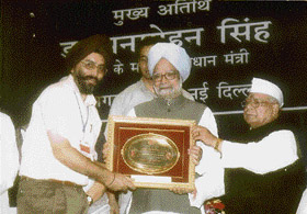 Chairman of the Raj Gram Udyog Samiti being conferred the National Award for Excellency in the field of khadi and village industry by Prime Minister Manmohan Singh in New Delhi
