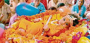 An infant dressed as Lord Krishna at a congregation to celebrate Janamashtami at the Sector 46 temple in Chandigarh on Monday.
