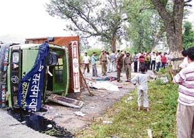 The ill-fated truck lies overturned on the highway near Nurpur