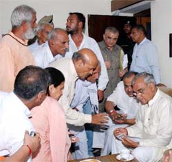 Chief minister Bhupinder Singh Hooda listens to grievances of the people at Karnal