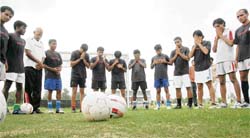 Players of the ONGC pray before starting practice for the Federation Football Cup at the PAU in Ludhiana on Monday. The first match is on Thursday.