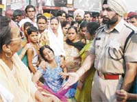 Police officials try to convince agitators to lift dharna and mob staging protest outside the GRP station.