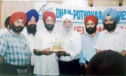 NS Nanda, president of the Dhan Pothoar Brotherhood, honouring Tara Singh Aalam, a famous UK based poet, writer and singer, during a function in Ludhiana on Sunday.