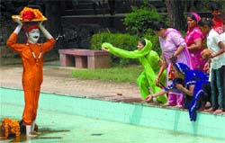 Devotees shower flower petals on a lifesize image of Vasudeva carrying the newly born Krishna on his head on the occasion of Janamashtmi at the Birla Mandir in the Capital on Tuesday.