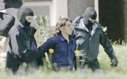 Cops escort a suspect (centre) from the German Federal Court of Justice in Karlsruhe
